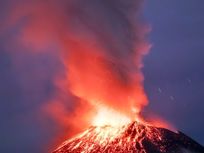 Incandescent materials, ash and smoke are spewed from the Popocatepetl volcano as seen from thr Sant...