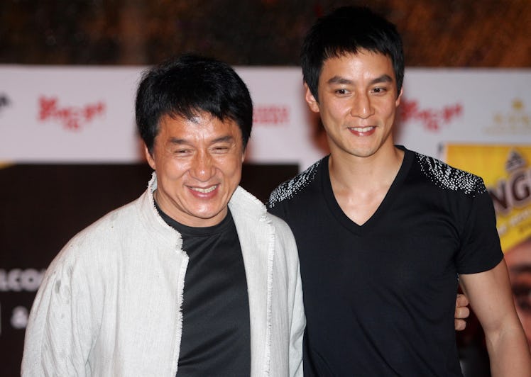 Hong Kong actors Jackie Chan (L) and Daniel Wu pose for photographers after a press conference in Ku...