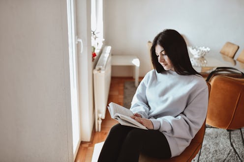 Beautiful Female Reading Favorite Book At Home
