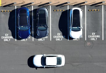 CORTE MADERA, CALIFORNIA - FEBRUARY 15: In an aerial view, Tesla cars recharge at a Tesla charger st...