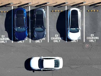 CORTE MADERA, CALIFORNIA - FEBRUARY 15: In an aerial view, Tesla cars recharge at a Tesla charger st...