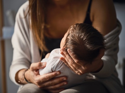 mother holding her baby, in an article about postpartum intrusive thoughts