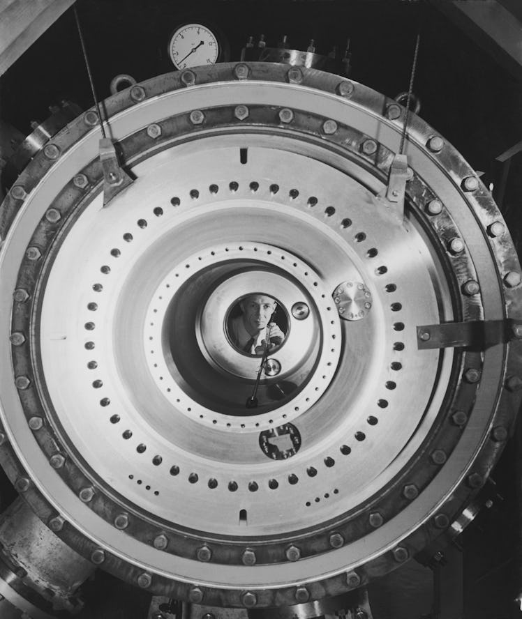 RCA engineer Gordon Simcox adjusts a probe to measure magnetic field inside a model C stellarator at...