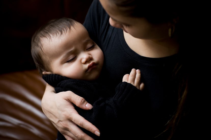 Goth baby names would fit this little baby, asleep in Mom's arms, both wearing black.