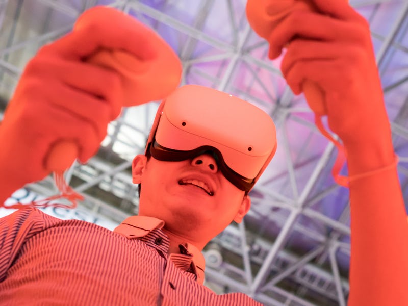 CHIBA, JAPAN - SEPTEMBER 15: An attendee wearing a Meta Quest 2 VR headset plays a video game at the...