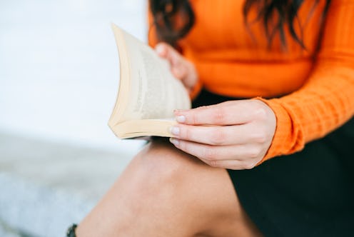 Close-up of woman's hands with book