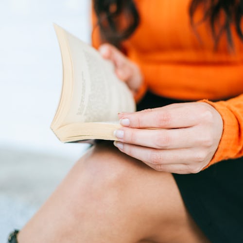 Close-up of woman's hands with book