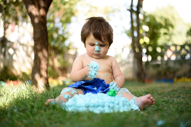 Baby playing with a cake during cake smash birthday party — a woman wants to know if it was okay to ...