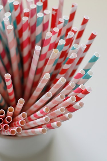 Close-up of paper straws in white pot