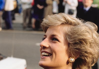 Princess Diana with feathered hair laughing in 1990