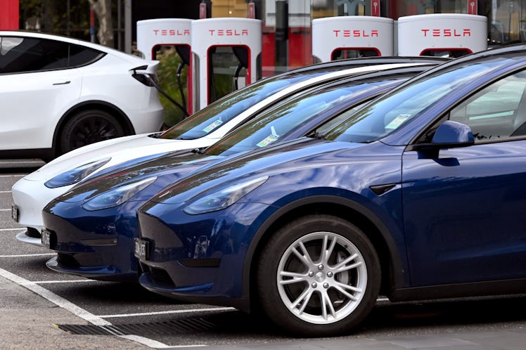 Electric vehicles (EV) line up outside a Tesla dealership in Melbourne on April 19, 2023. (Photo by ...