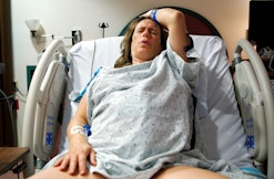 A mother giving birth to her baby in the hospital, in a story about childbirth videos.