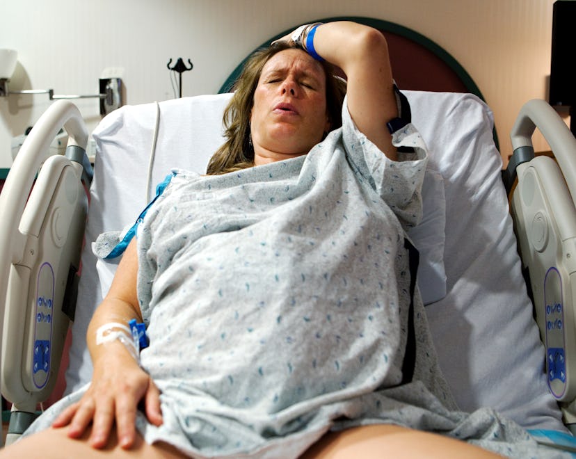 A mother giving birth to her baby in the hospital, in a story about childbirth videos.