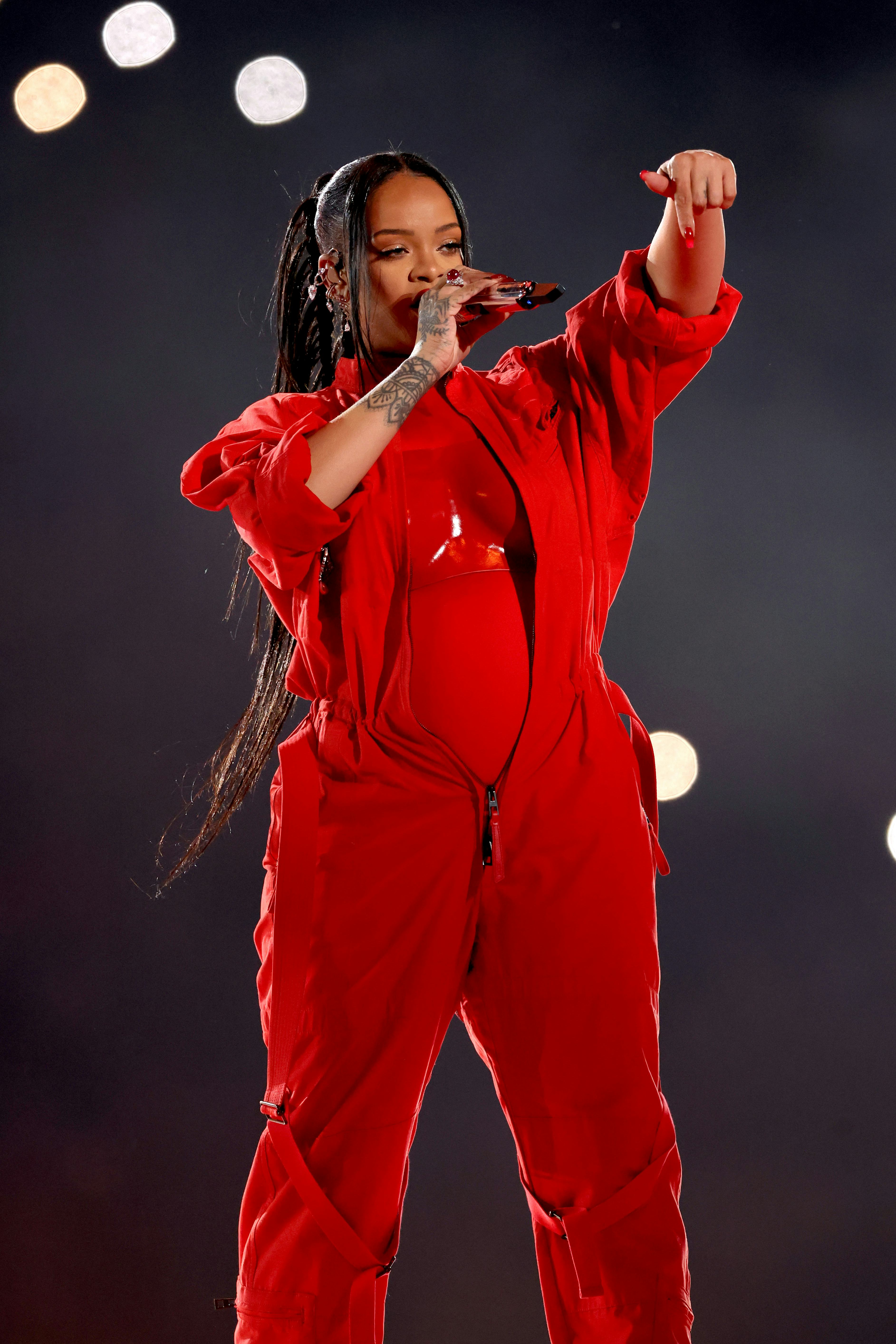 Rihanna wears a red breast plate and boiler suit to perform during the Apple Music Super Bowl LVII H&hellip;