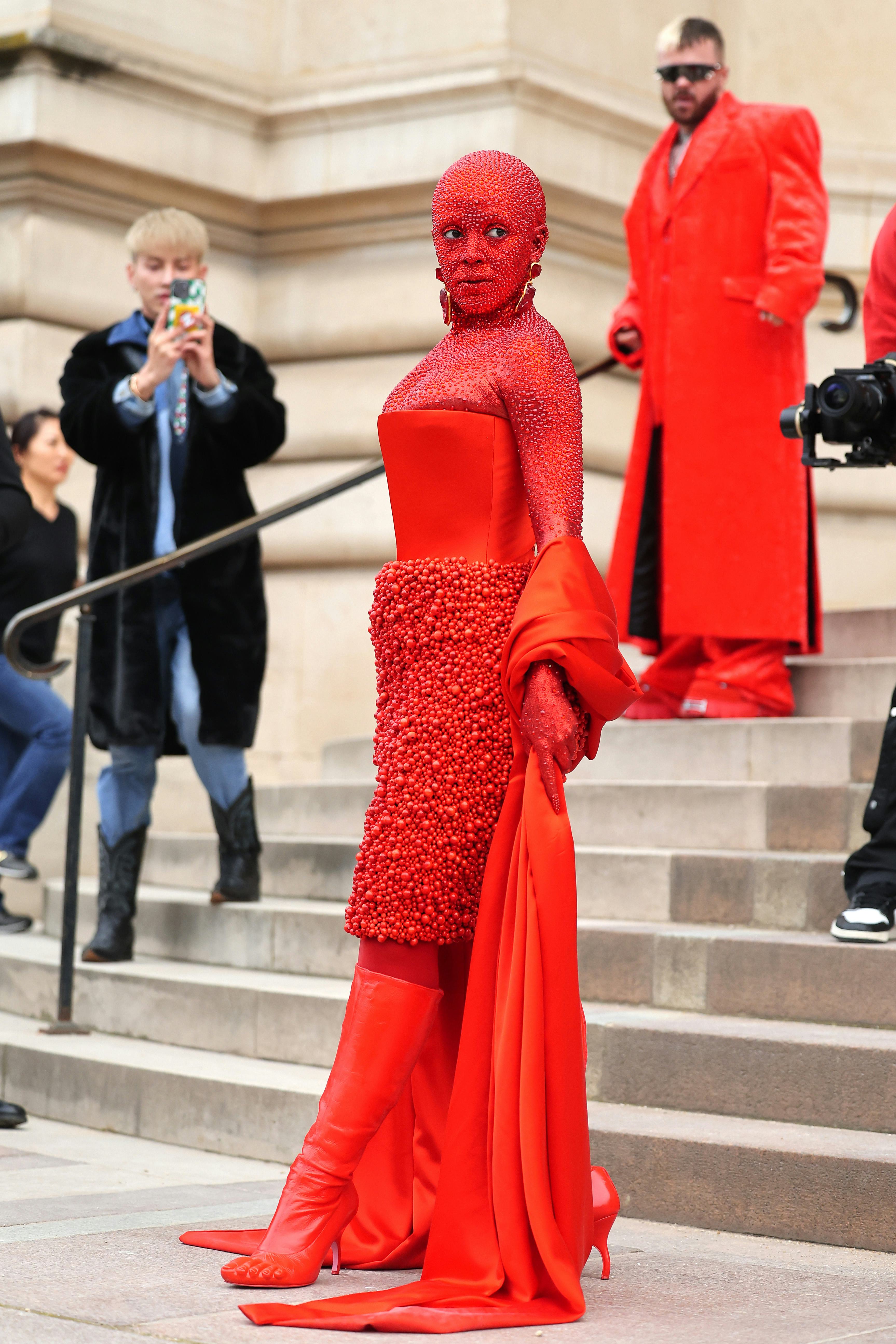 Doja Cat wears an all-red outfit to attend the Schiaparelli Haute Couture Spring Summer 2023 show.
