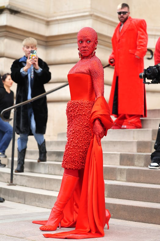 Doja Cat wears an all-red outfit to attend the Schiaparelli Haute Couture Spring Summer 2023 show. 