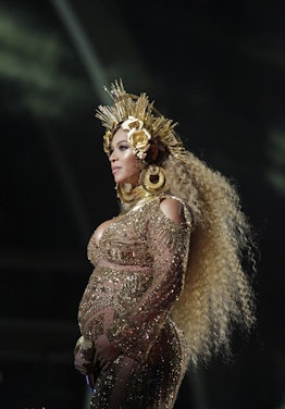 Beyonce performs during THE 59TH ANNUAL GRAMMY AWARDS with wavy blonde hair.