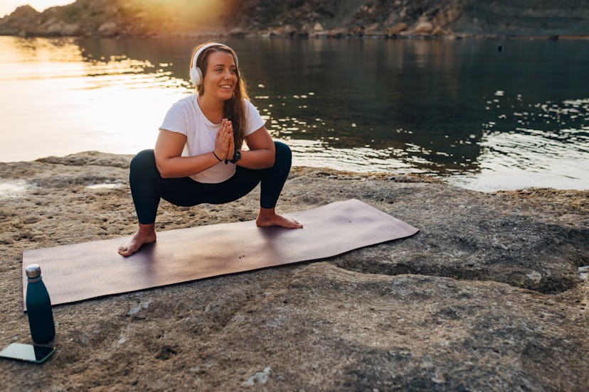 A deep yoga squat will wake up tight hips mid-road trip.