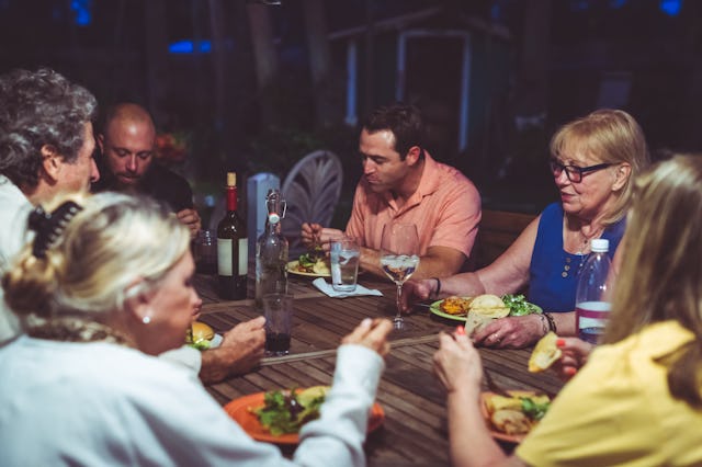 Candid family meal eating together with family