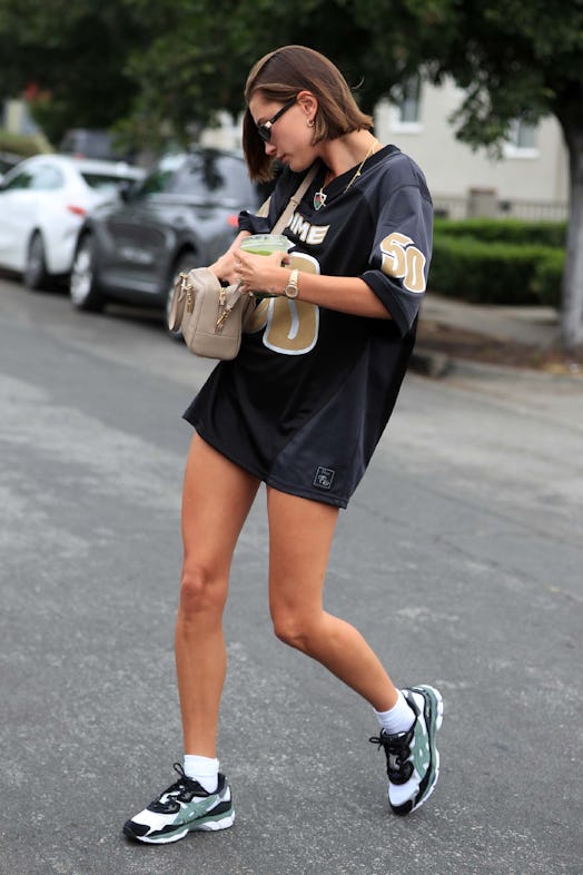 Hailey Bieber wears the "no pants" look in a jersey and sneakers while out in Los Angeles, Californi...
