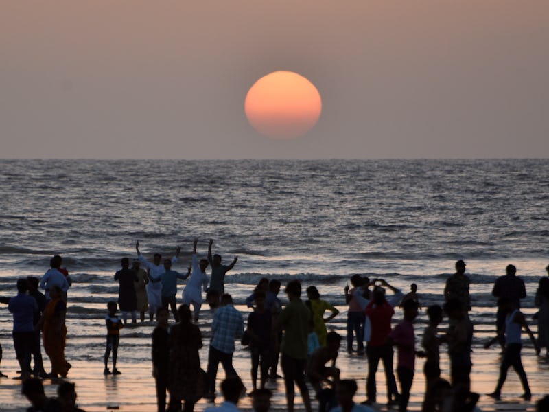 Indian muslims spent sunset time on the day of Eid al-Fitr, near a sea beach in Mumbai, India, 22 Ap...