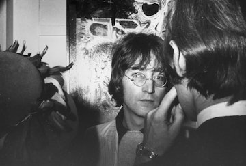 John Lennon (1940 - 1980) surrounded by people at an art exhibition, 1969. (Photo by Andrew Maclear/...