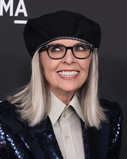 Diane Keaton long gray hair with flipped ends and beret hat