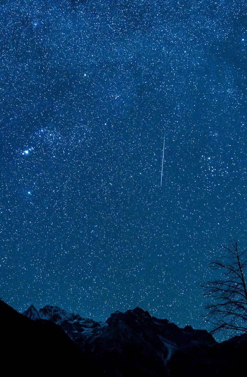 Photo taken on Dec. 14, 2021 shows a meteor of Geminids meteor shower at the Yulong Snow Mountain in...