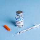 High angle view of syringe and mRNA vaccine multidose vial for cancer immunotherapy (We look forward...