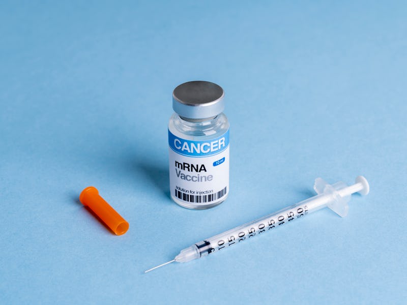 High angle view of syringe and mRNA vaccine multidose vial for cancer immunotherapy (We look forward...