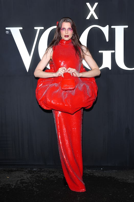 Julia Fox wears a red sequin dress with an oversize peplum and butt cut-outs. 