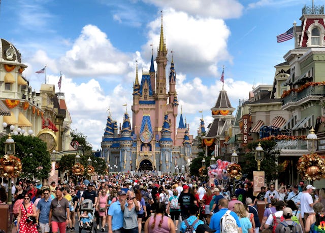 Crowds fill Main Street USA in front of Cinderella Castle at the Magic Kingdom on the 50th anniversa...