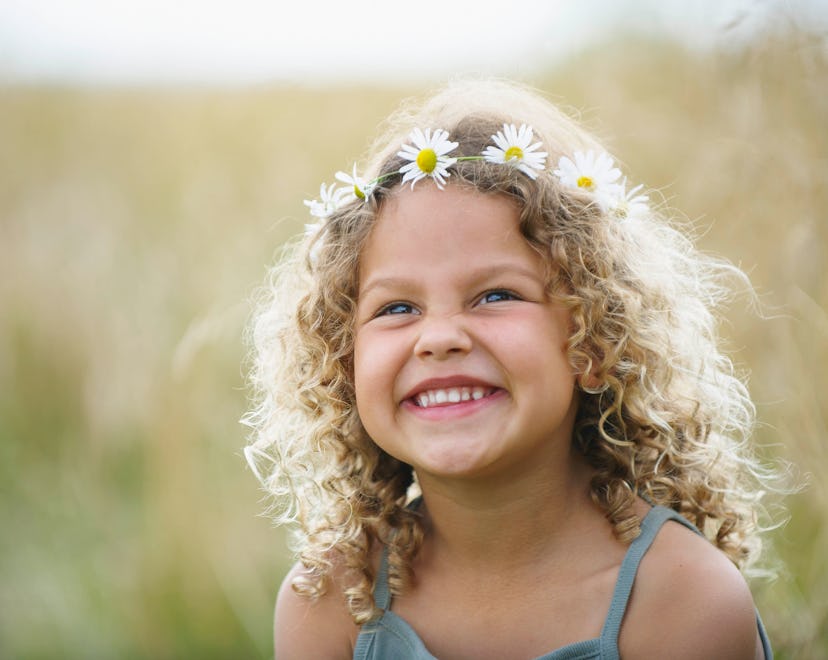 adorable toddler celebrating summer solstice tradition of flower crowns