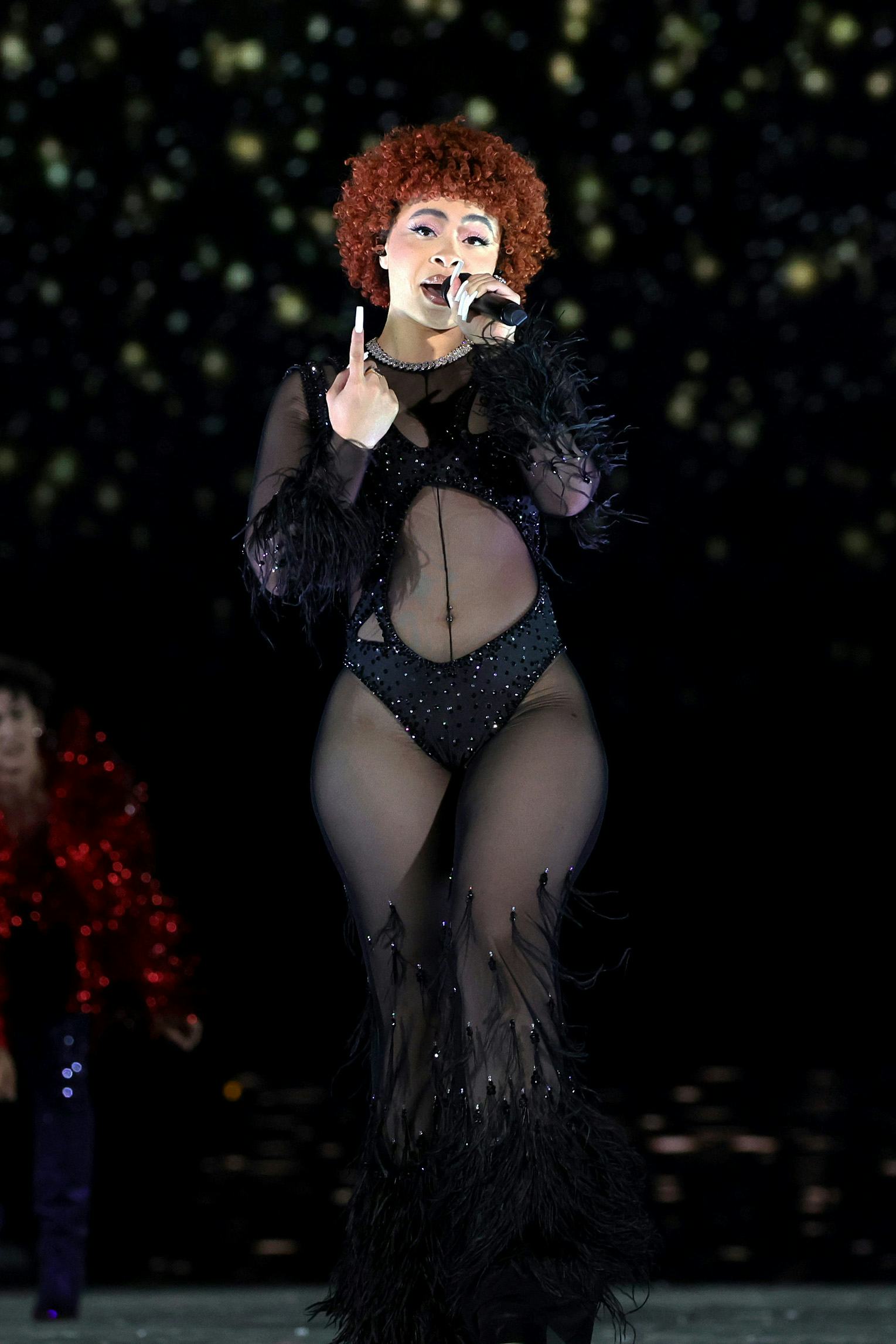 Ice Spice performs in a Theophilio sheer jumpsuit during Taylor Swift&rsquo;s Eras Tour.