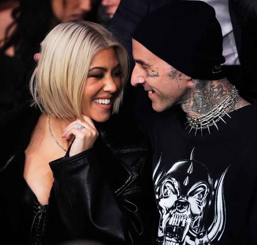 Kourtney Kardashian used a concert sign to tell Travis Barker she's pregnant.
