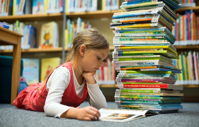 Six-year-old Amy reads in a book at the childrens' library in Frankfurt Oder, Germany, 11 September ...