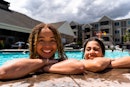 Against the backdrop of a sun-kissed pool, two multi-racial girls, aged 13 to 15, exude joy and frie...