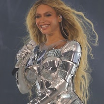 Beyoncé performs onstage in a silver armor-like onesie during the “RENAISSANCE WORLD TOUR."