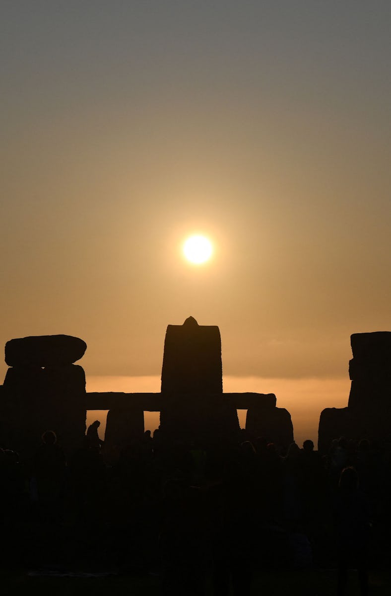 TOPSHOT - The sun rises at Stonehenge, near Amesbury, in Wiltshire, southern England on June 21, 202...