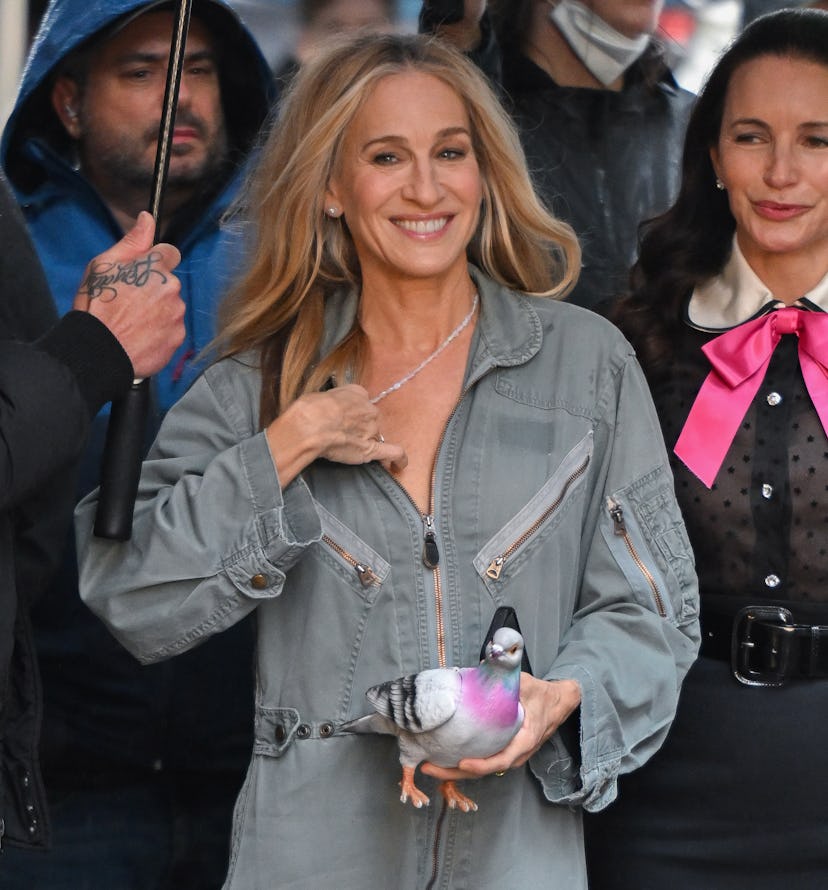 Sarah Jessica Parker wears a jumpsuit and a pigeon clutch while on the set of "And Just Like That......