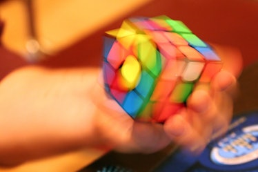 A Rubik's Cube is being solved so fast it's blurry in the photo