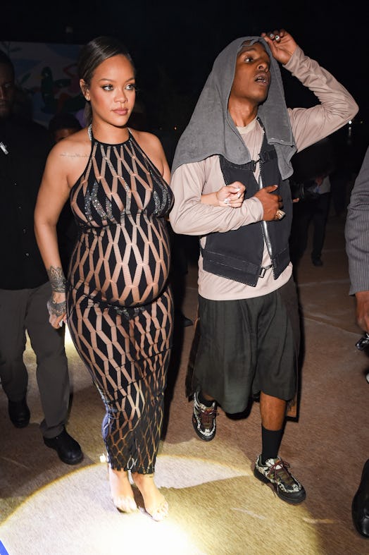 Rihanna wears a sheer jumpsuit with a sparkly bikini and A$AP Rocky wears streetwear. 