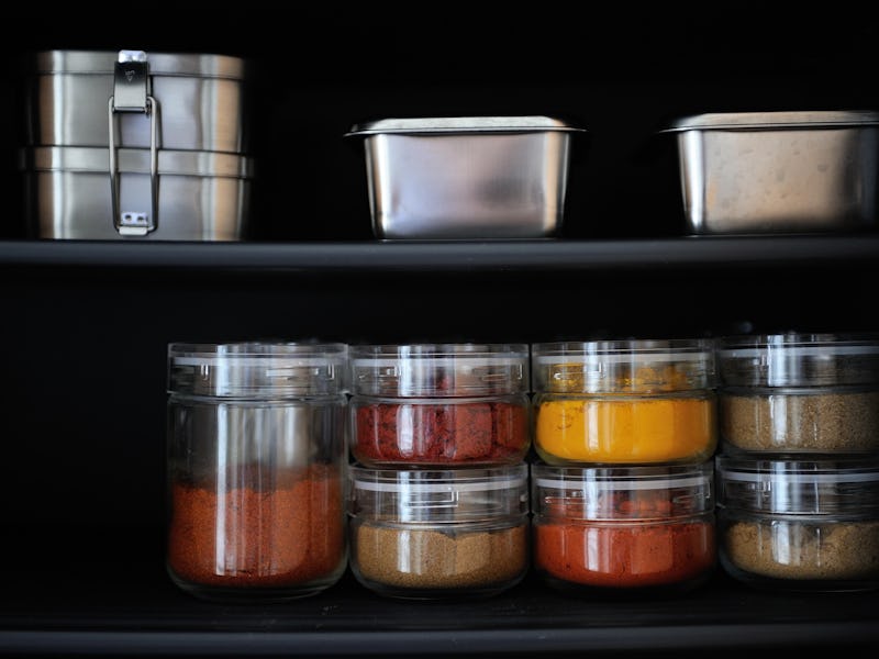 TOKYO, JAPAN - JUNE 29 : Metallic box and jars of spices are seen in a kitchen cupboard of minimalis...