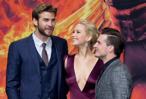 BERLIN, GERMANY - NOVEMBER 04: (L-R) Liam Hemsworth, Jennifer Lawrence, wearing a Dior dress and Jo...