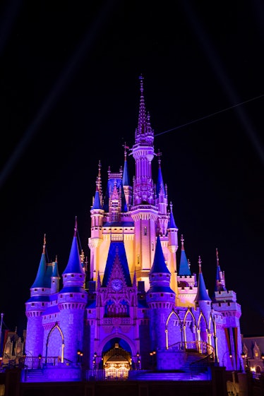 Cinderella Castle inside the Magic Kingdom Park is lit purple and gold in honor of the Los Angeles L...