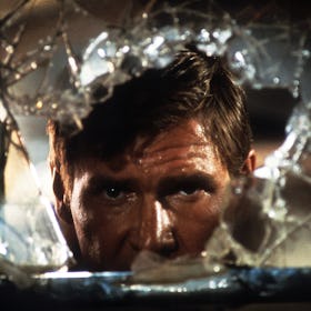 Harrison Ford looks through broken glass in a scene from the film 'Indiana Jones And The Temple Of D...