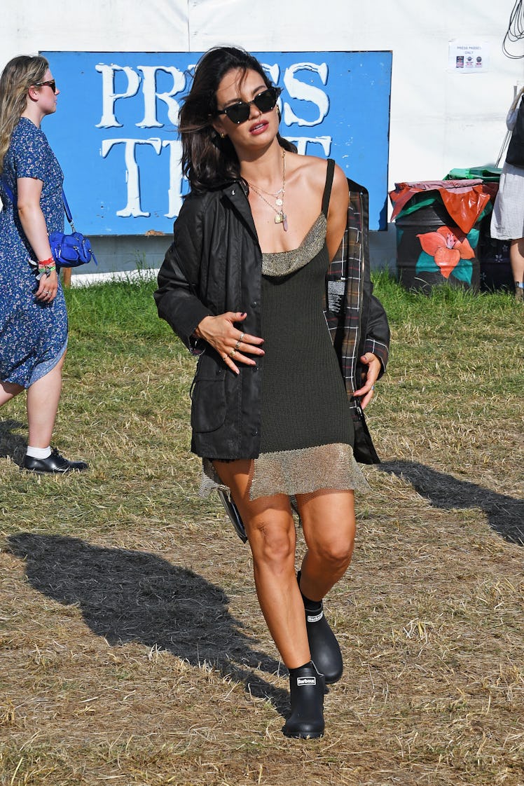 Lily James is seen on day one of the Glastonbury Festival wearing her Barbour wax jacket 