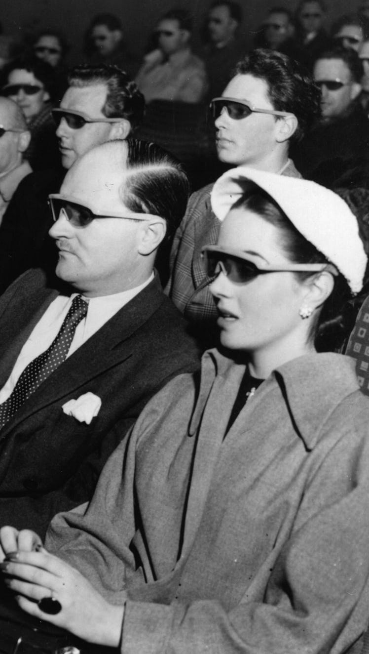 Cinema-goers wearing 3D glasses at a special Festival of Britain three dimensional film screening.  ...
