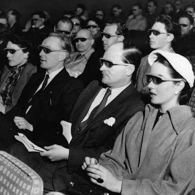 Cinema-goers wearing 3D glasses at a special Festival of Britain three dimensional film screening.  ...