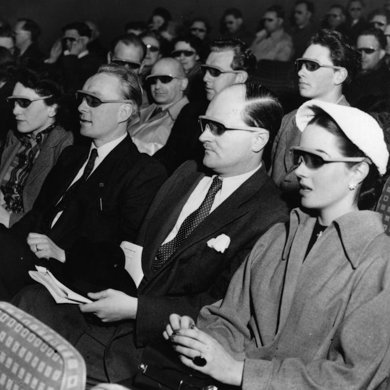 Cinema-goers wearing 3D glasses at a special Festival of Britain three dimensional film screening. ...